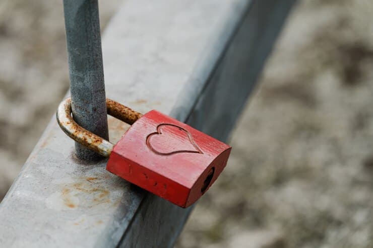 444 twin flame - a key inscribed with the love sign and locked into a chair